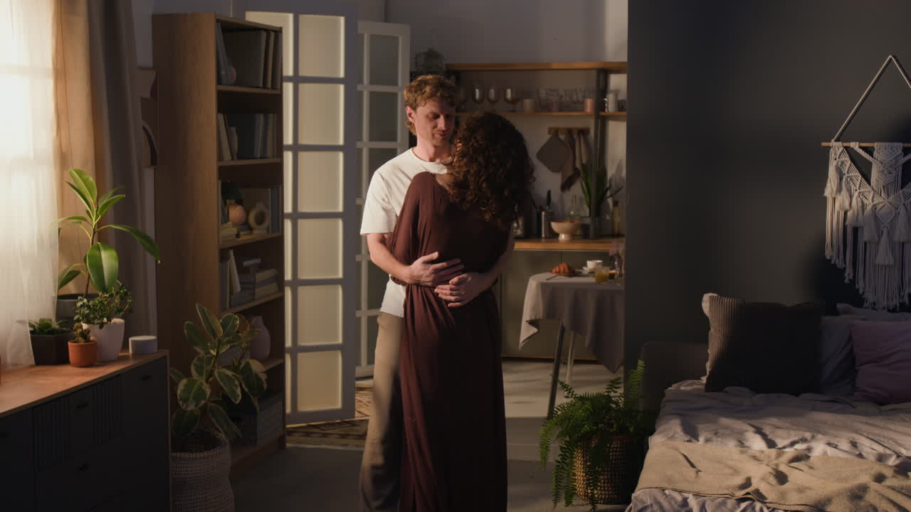 Couple hugging intimately in their bedroom at home