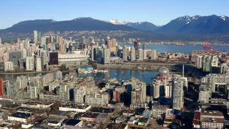 false creek surrounded by bc place stadium, hotel, and skyscrapers in downtown vancouver, canada