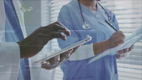animation of data processing over mid section of doctors using digital tablet and writing reports