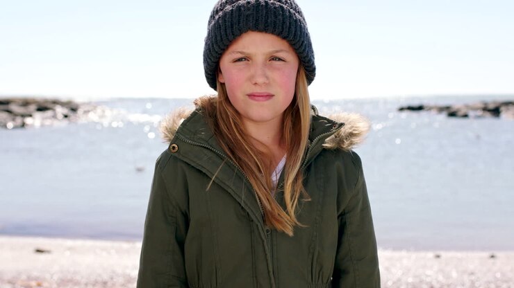 Face, smile and girl at beach on vacation