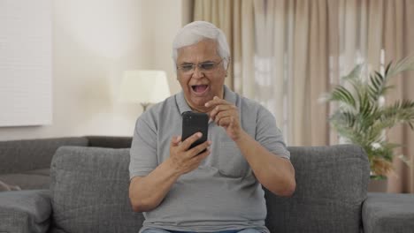 Sleepy-Indian-old-man-scrolling-through-phone