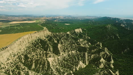 Farmfields-on-edge-of-lush-hilly-valley-in-Vashlovani,-Georgia