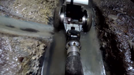 A-small-inspection-camera-vehicle-is-entering-a-sewage-pipe