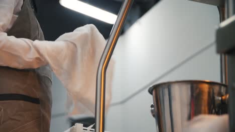 restaurant worker cleaning equipment