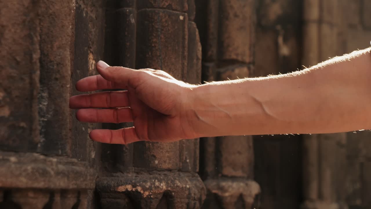 Touching old castle wall, Happy tourist man in Barcelona, Spain. Vacation exploring interesting places to travel, student vacation, young man portrait walking in gothic square, old european city