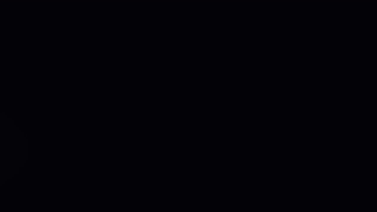 Animation of lens flare and dust moving against black background