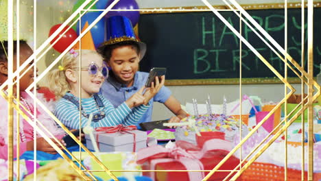 animation of gold shapes over diverse children using smartphone at birthday party