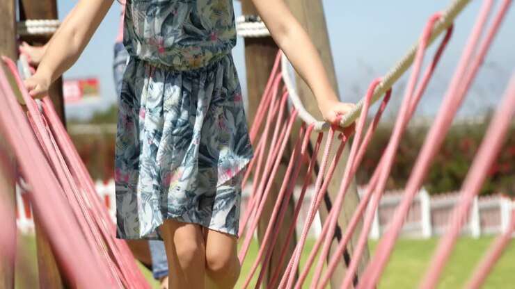 Bambini che camminano su un ponte di corda in giardino 4k