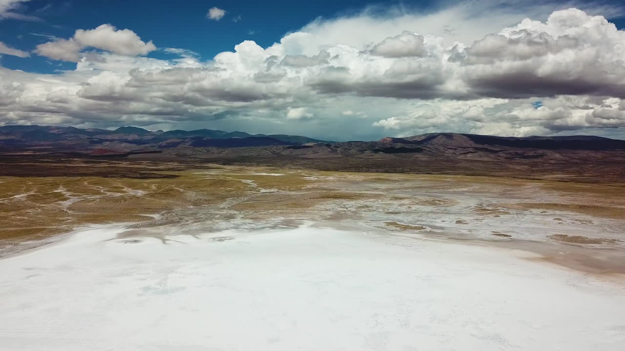 Cinematic Aerial View of Salt Flat in Valley Under Volcanic Hills. Salinas Grandes, Salta, Argentina