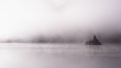 foggy dramatic scene looking across swan lake in montana