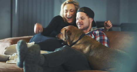 man having fun with dog at home 1