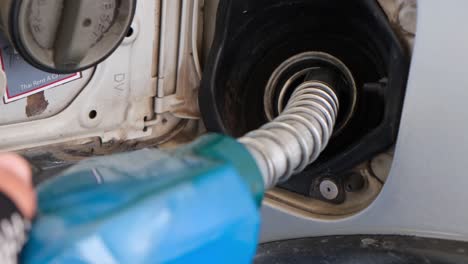 Fuel-nozzle-being-taken-out-after-filling-the-fuel-tank-of-a-truck,-gas-station-in-Thailand