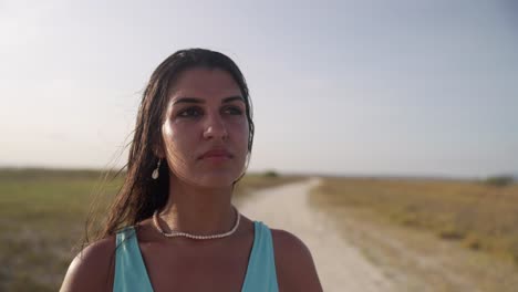 Beautiful-brunette-latina-women-with-blue-top-and-jewellery-looking-in-the-distance-on-Coche-Island,-Venezuela