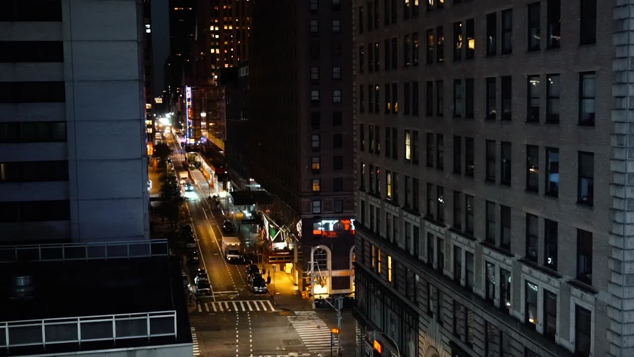 Vehicles On The Streets With Contemporary Buildings In New York City At Night - high angle, static shot