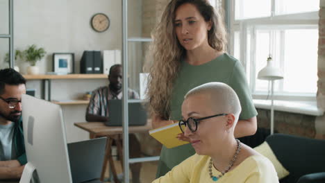 dos mujeres de negocios discutiendo un proyecto en la computadora en la oficina