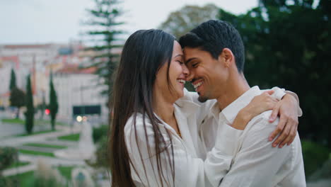 Vertically-closeup-romantic-pair-cuddling-street.-Happy-woman-kissing-boyfriend