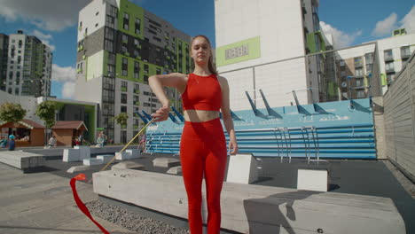 woman twirling red ribbons in urban setting