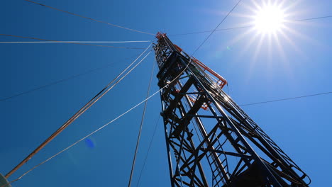 metal wires are attached to the metal support from different sides. low angle view on the tower for drilling resources.