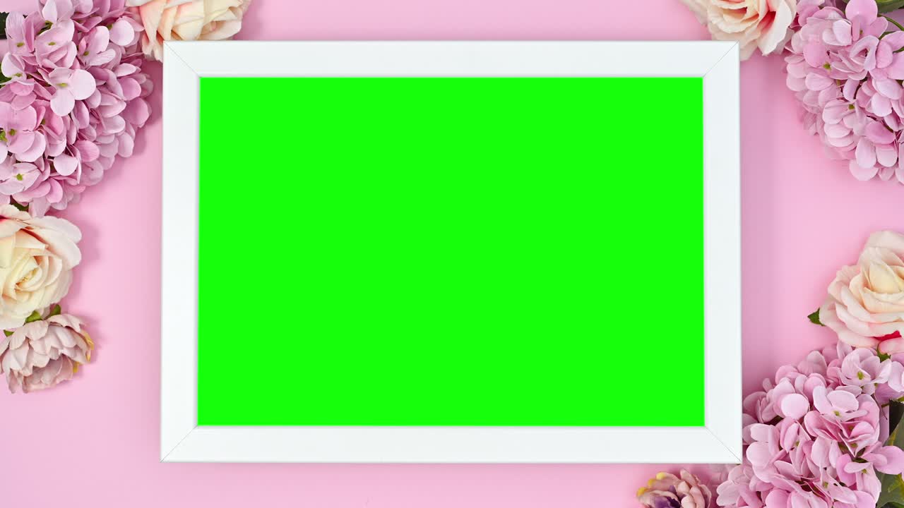 Green screen frame surrounded with romantic flowers. Stop motion animation