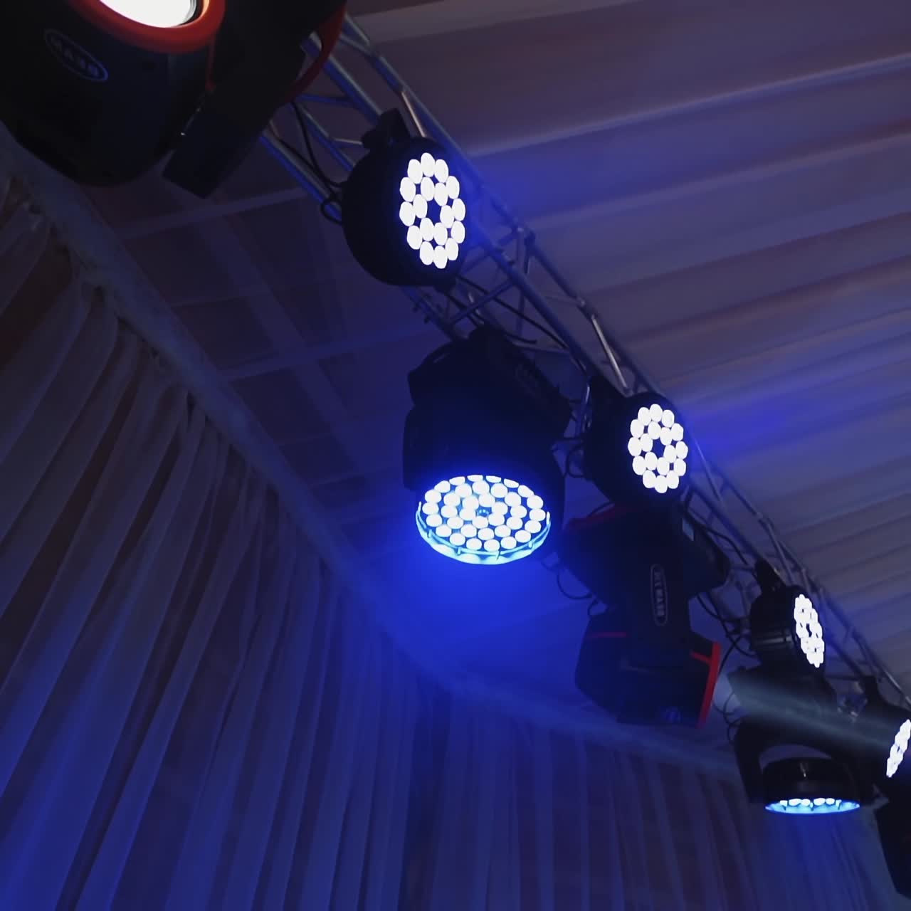 Musical spotlights. Colorful lights from projectors shimmering in the dancing hall. Modern equipment shining with different colors.