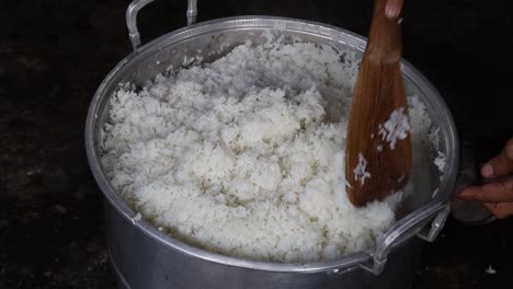 someone is cooking rice in the pot