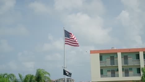 the american flag waving in slow motion shot from passing car