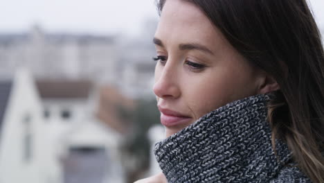 woman in profile view wearing a scarf