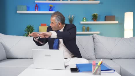 home office worker man dances looking at camera.
