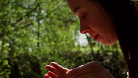 hands cupping water from a stream