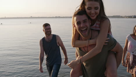 group of friends having fun on the beach