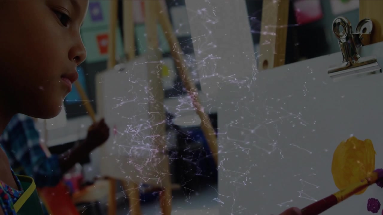 Girl dipping brush into yellow paint creating circle with purple dots widening revealing students