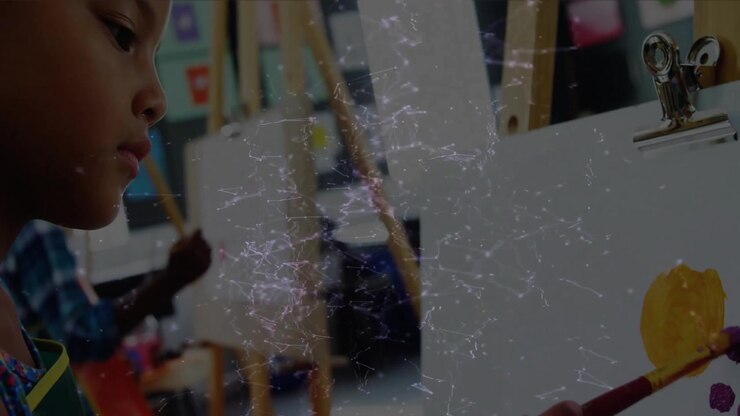 Girl dipping brush into yellow paint creating circle with purple dots widening revealing students