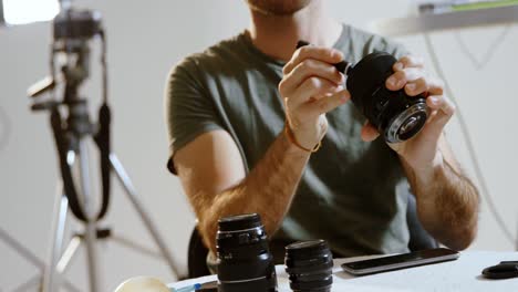 male photographer cleaning camera lens 4k