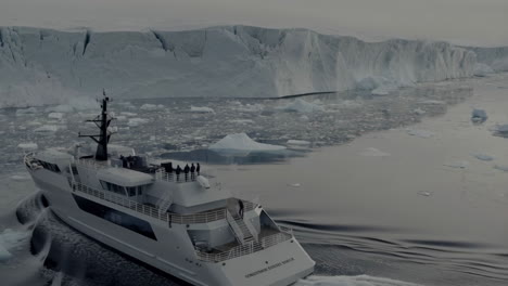 luxury yacht exploring icy polar waters with majestic icebergs and glaciers
