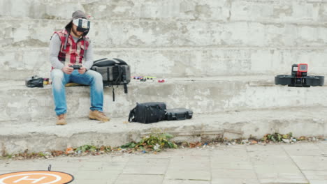 a man pilots a drone in a helmet with a video screen first-person sports piloting