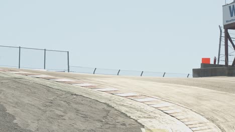 a pair of sleek corvette, sports cars glides down a hill on a racetrack. captured 4k and shot at 60 fps in slow motion.