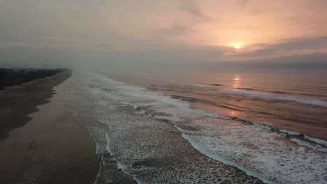 Phenomenal-opening-aerial-shot-of-Atlantic-ocean-in-sunrise-time-in-Brazil,-beautiful-waves-and-sun