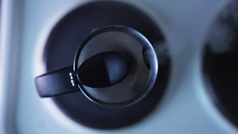 top shot of an espresso coffe machine standing on a stove and cooking