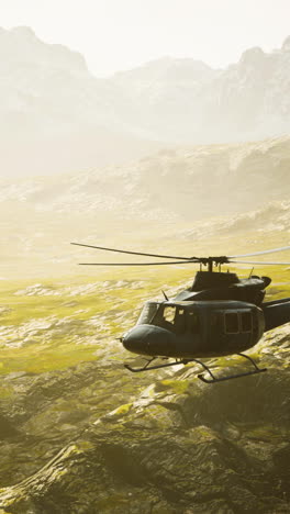 military helicopter flying over a desert landscape