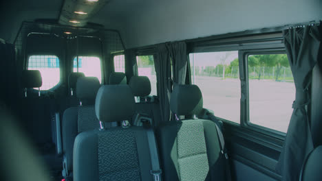 amazing slow motion shot of the seats inside a very large, elegant and modern black van for transporting musical bands in madrid