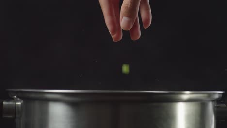 adding vegetables to a pot