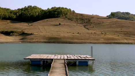the pier made of wood in the lake. reflections on the lake.