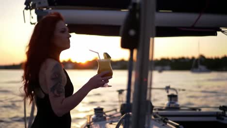 a relaxing evening on a sailboat: enjoying a colorful cocktail against a serene sunset background with vibrant colors and peaceful waters