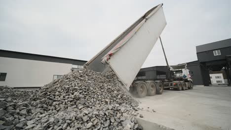 a truck dumps rubble onto a construction site. clearing site