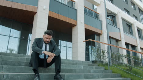 depressed businessman sitting on stairs