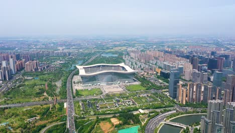 expansive drone shot of the new century global center, the world's largest building, with cityscape during the day in chengdu, sichuan. china