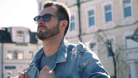 stylish man in denim jacket and sunglasses