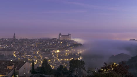 illuminated historic city on hill in evening