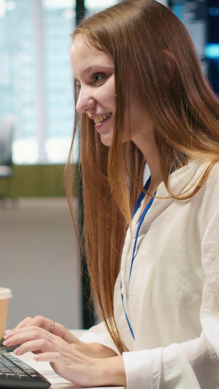 Vertical video Young female programmer uses computer to write code, developing machine learning