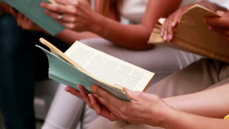 casual business team sitting reading books